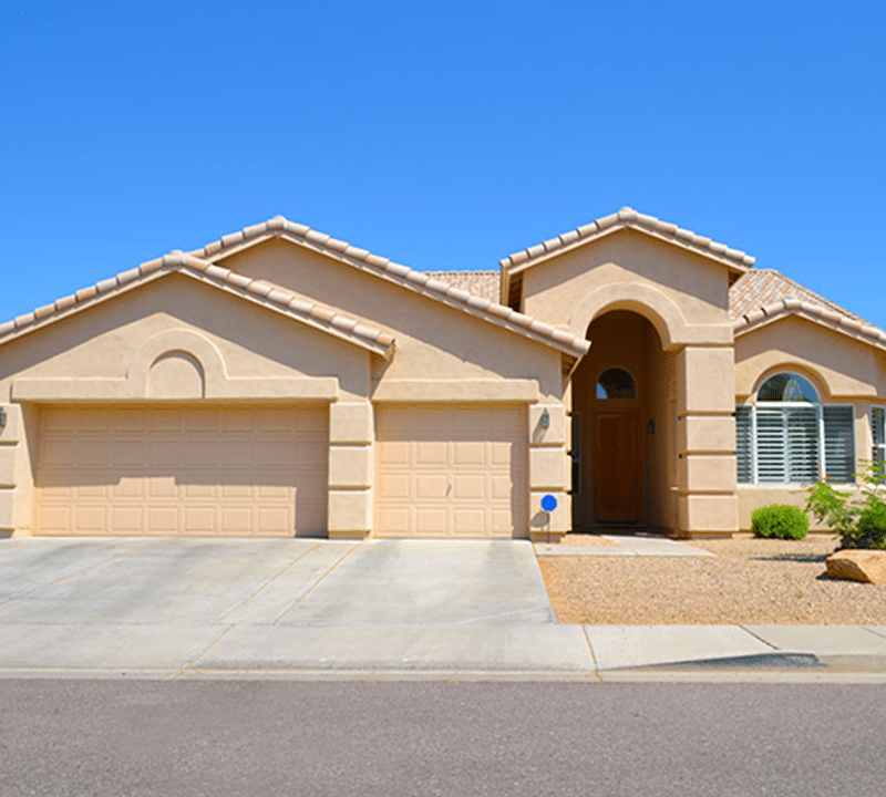 Desert home with garage and cactus