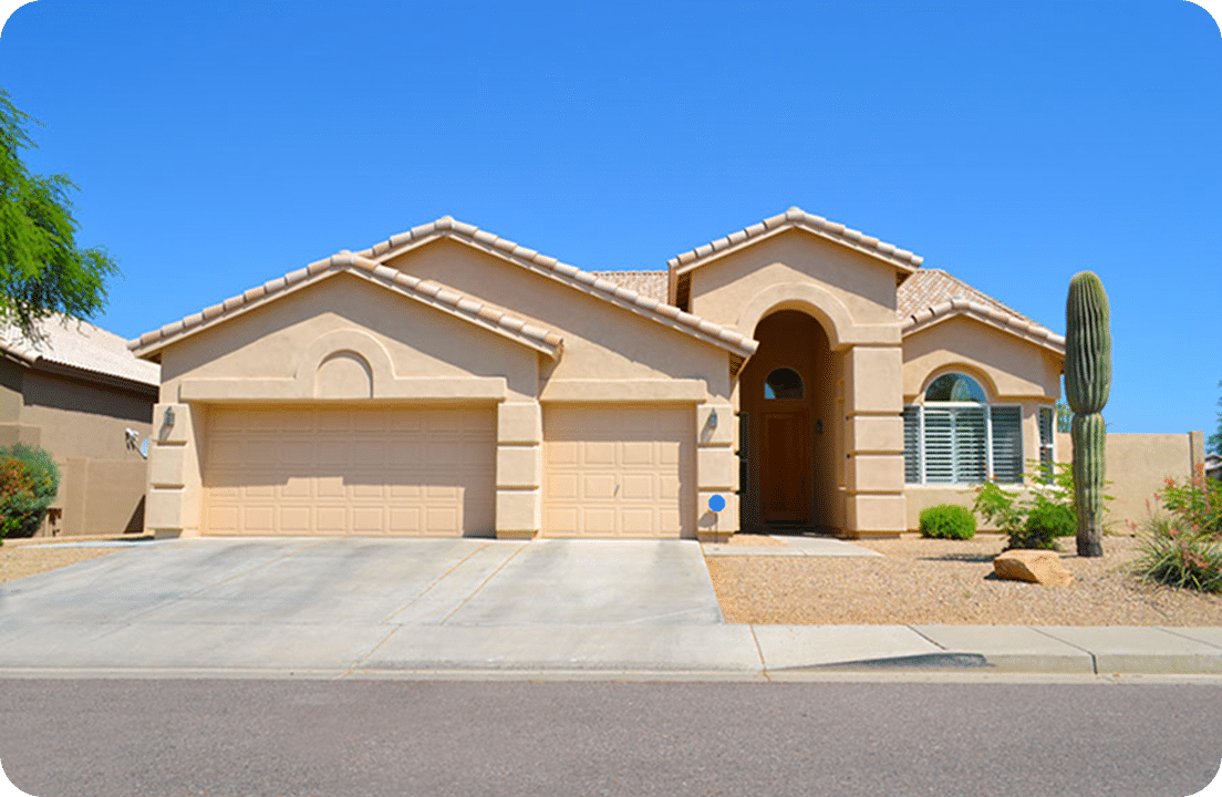 Desert home with garage and cactus